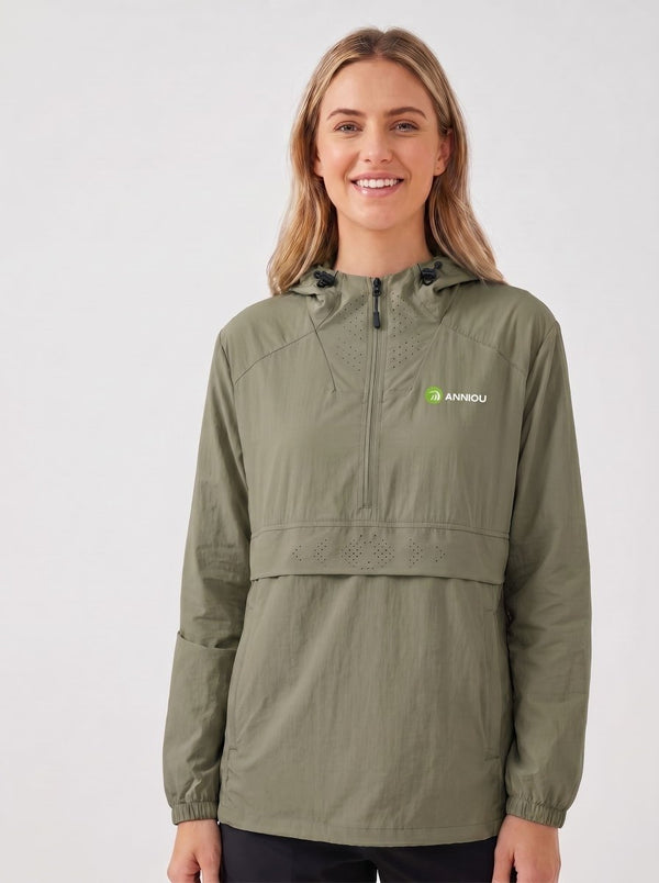 A woman wearing an #green hooded lightweight jacket with a half-zip front and a small green and white Anniou logo on the left chest, photographed against a light gray studio background.