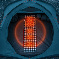 Heated grey camping mat inside a tent with glowing orange heat indicator