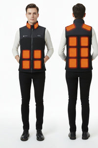 Black heated vest with orange heating elements worn by a person on a white background 