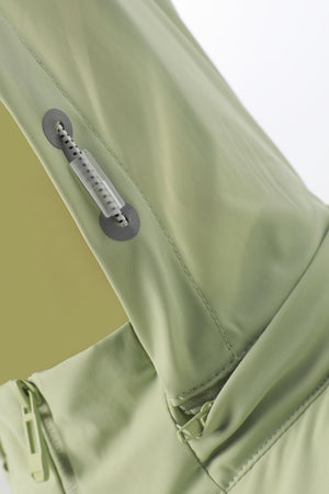 Close-up of a green jacket with zippers on a light gray background
