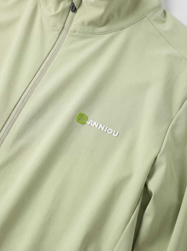 Close-up of a #lightgreen zip-up jacket with the Anniou logo embroidered in green and white on the chest.