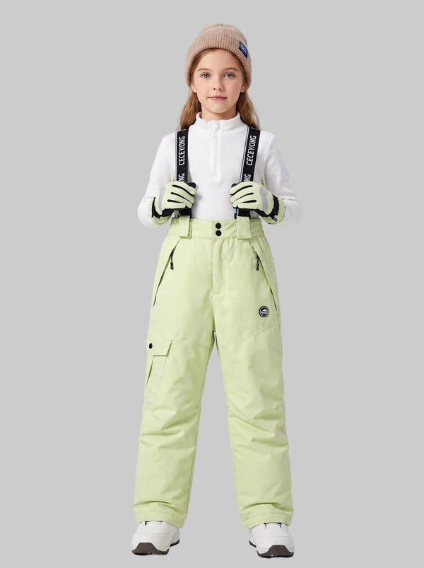 A young girl models a #lemonyellow kids' suspender ski pants.