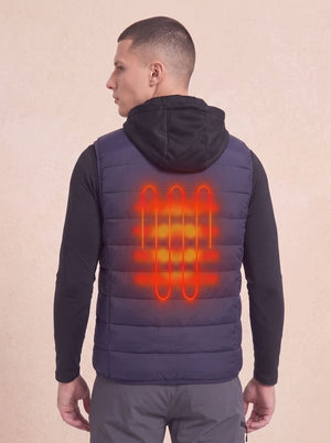 A man shown from the back wearing a dark navy quilted heated puffer vest with 1 heat zone.