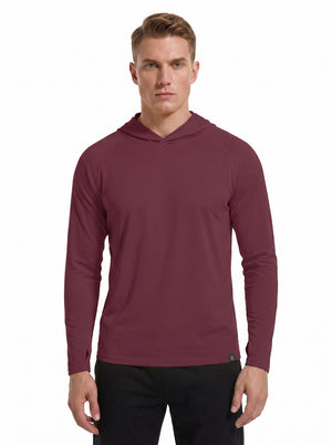A male model wearing a #maroon hooded long-sleeve performance shirt and black athletic pants stands against a plain white background. 