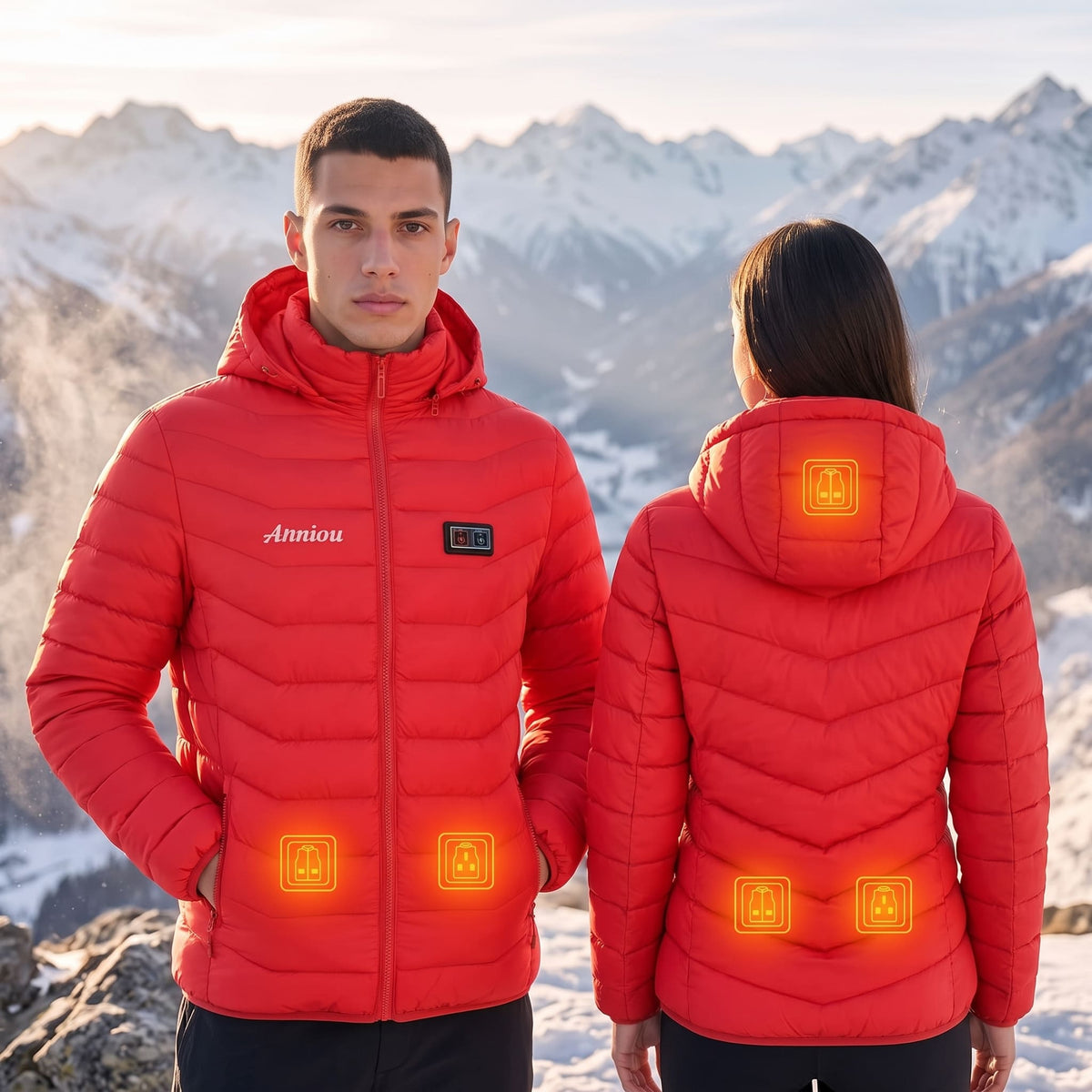 A man and a woman wearing matching red heated puffer jackets, shown from the front and back respectively, set against a snowy mountain background. The jackets feature glowing orange heat indicators on the chest and back.