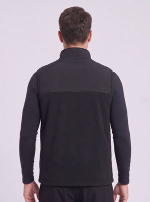 A man viewed from the back wearing a black heated fleece gilet