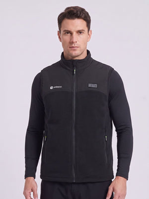 A man wearing a black zip-up fleece heated vest with a stand-up collar, shown from the waist up against a light gray studio background. The vest has a white 'ANNIOU' logo on the left chest and triple control on the right chest.