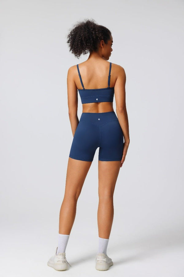 Woman wearing a #Navy blue Anniou Logo adjustable seamless sports bra and Anniou logo high waist yoga shorts 