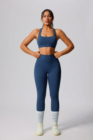 Woman wearing a #navy blue yoga outfit with a sports bra and high waist leggings
