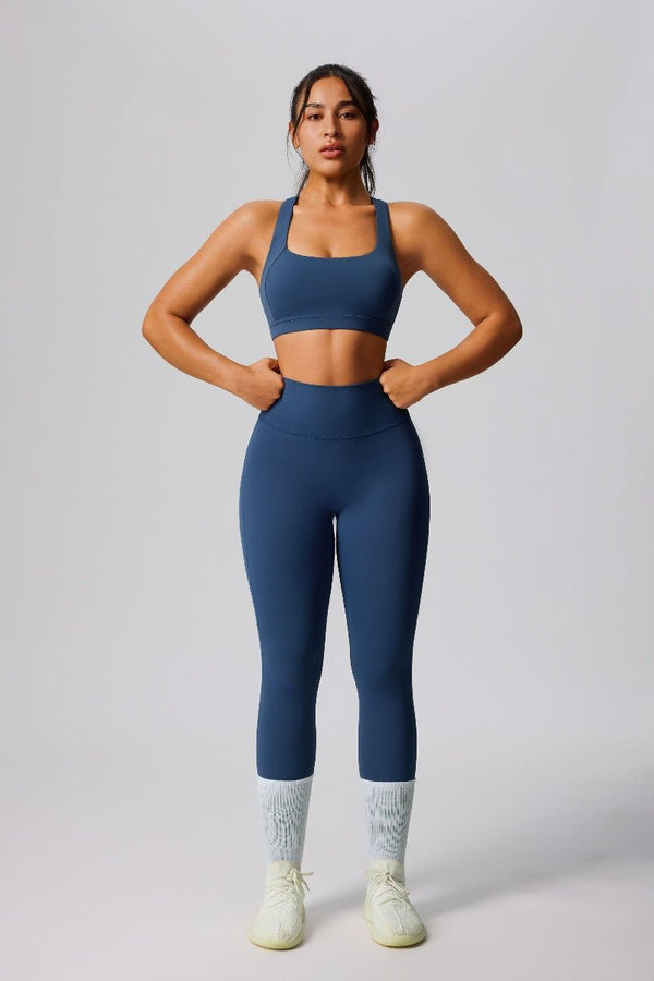 Woman wearing a #navy blue yoga outfit with a sports bra and high waist leggings