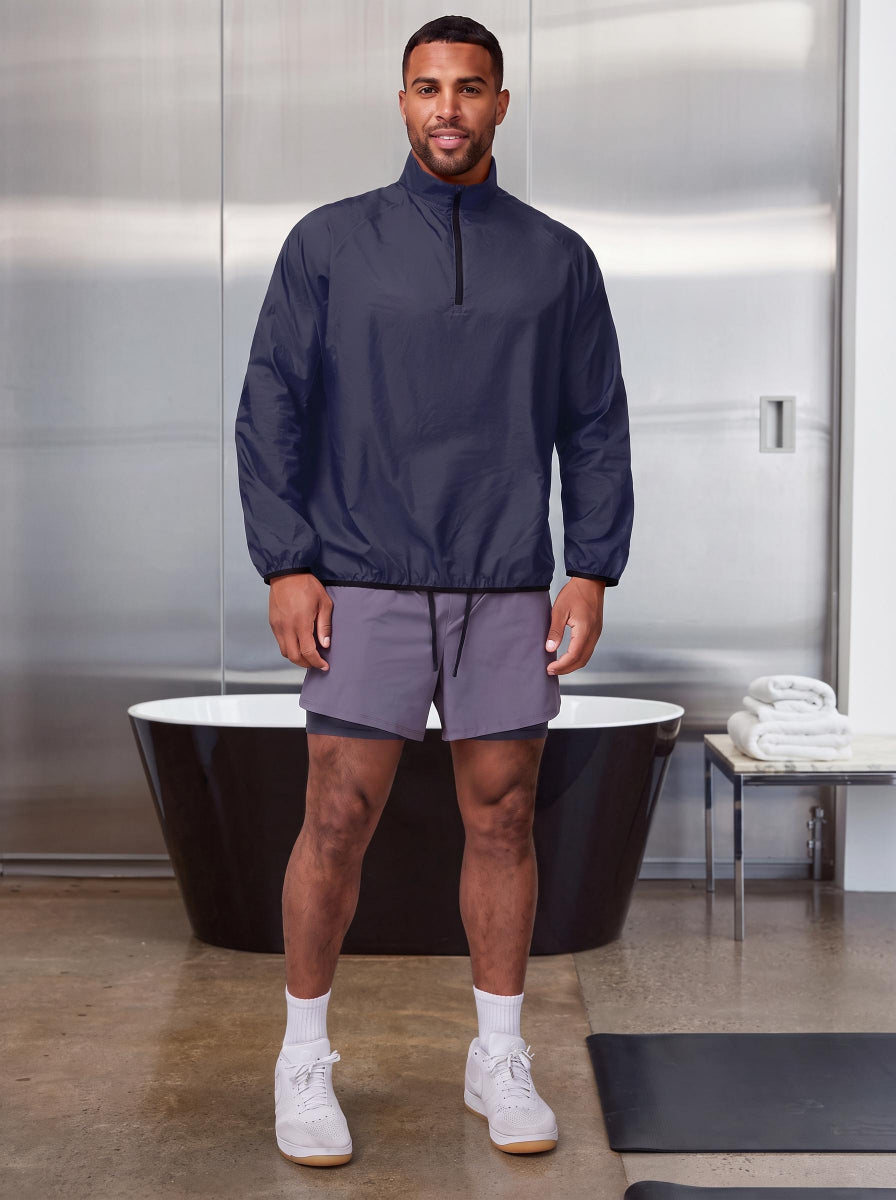 Male model wearing #navy quarter-zip lightweight wind pullover and grey 2-in-1 athletic shorts,