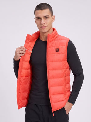 A man wearing a bright red quilted puffer vest over a black long-sleeve shirt.