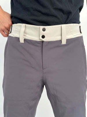 Close-up of a person wearing gray ski pants with a contrasting light beige belt