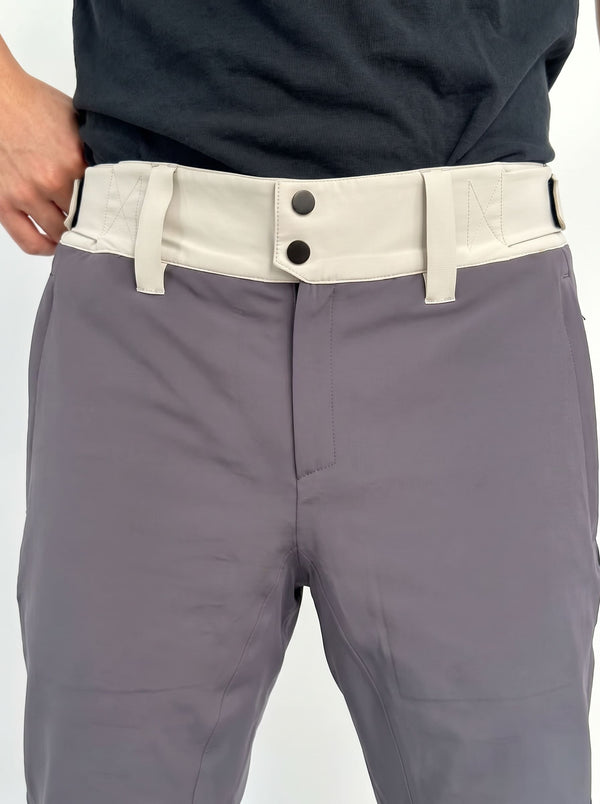 Close-up of a person wearing gray ski pants with a contrasting light beige belt