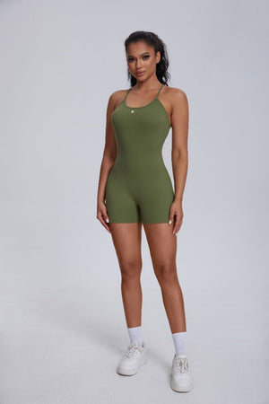 Woman wearing a #green sports jumpsuit with upf 50+ protection for yoga