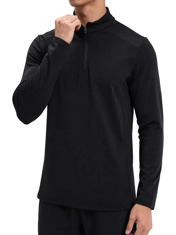 Male model adjusting the zipper of #black half-zip long sleeve sports top, plain background.