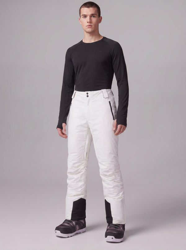 A male model wearing a black long-sleeve thermal top stands against a plain grey studio background to showcase #white insulated men’s ski pants 