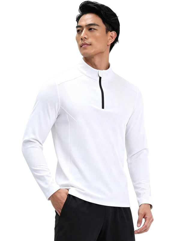 Male model in #white half-zip long sleeve sports top with one hand in pocket, plain background.