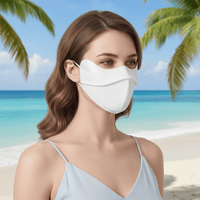 Woman wearing a white face mask on a tropical beach with palm trees and clear blue water.
