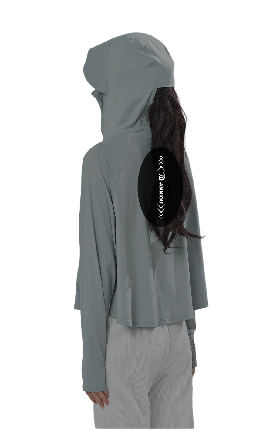 Person wearing a light gray hooded jacket with a black pouch on a gray background