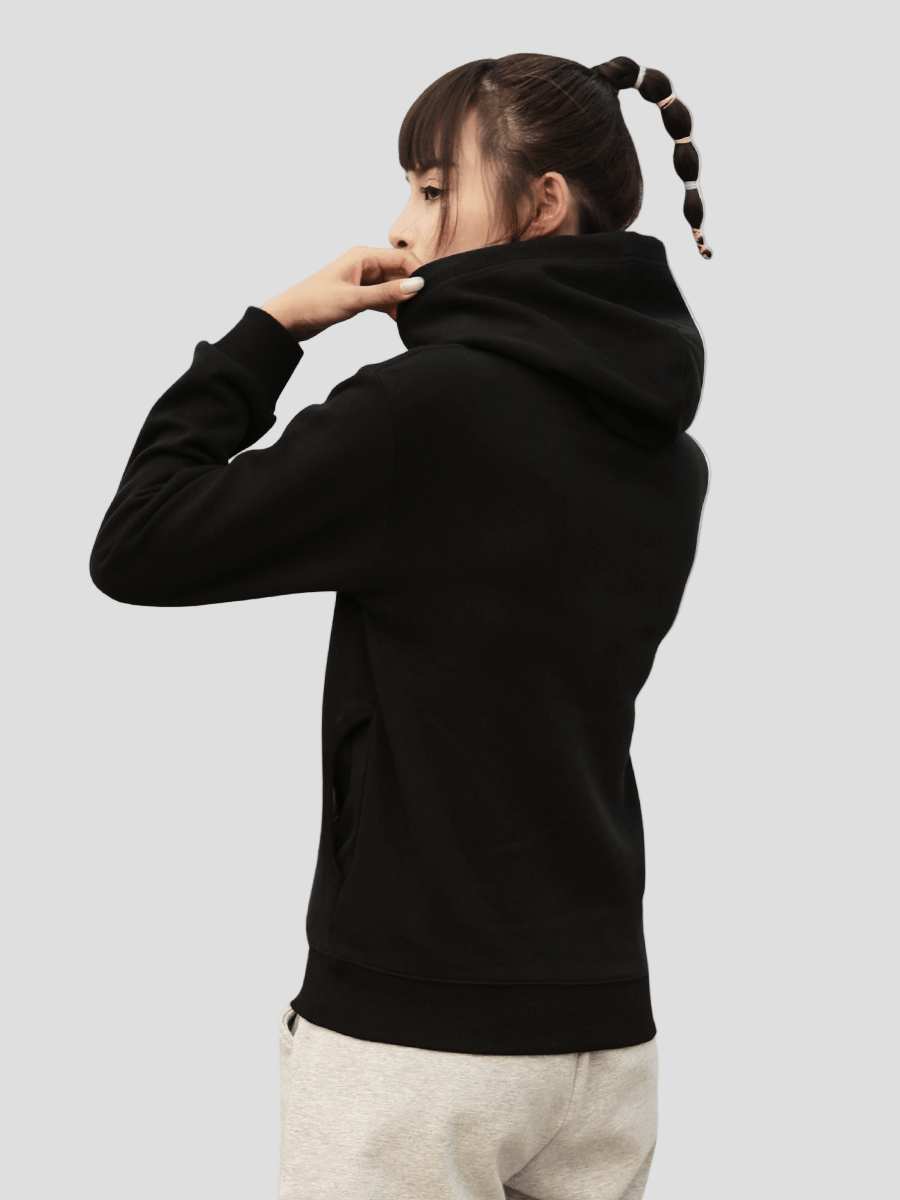 Person wearing a black hoodie on a plain background