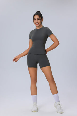 Woman wearing a #gray athletic outfit on a white background