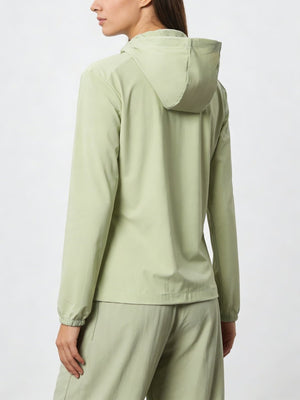 Person wearing a #lightgreen hooded jacket and pants  from the back