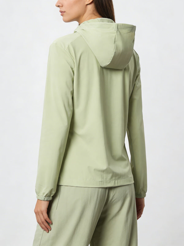 Person wearing a #lightgreen hooded jacket and pants  from the back
