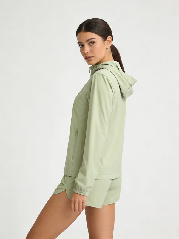 A woman modeling a #lightgreen hooded jacket and matching shorts 