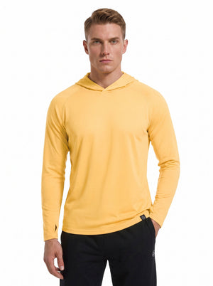 A male model wearing a #yellow hooded long-sleeve performance shirt and black athletic pants stands against a plain white background.
