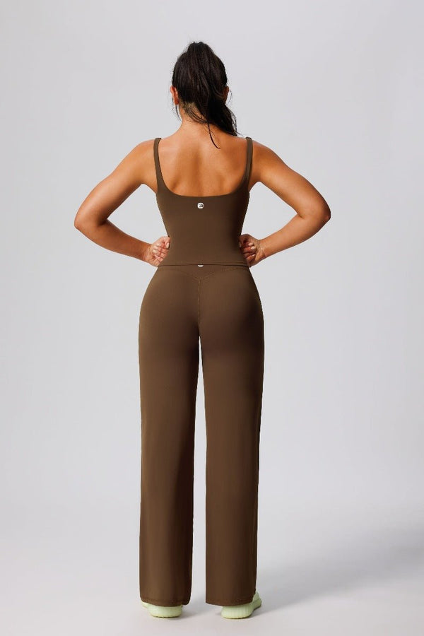 Woman wearing a #brown jumpsuit  from the back vest and leggings 